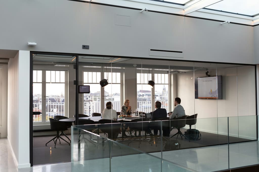 Business procurement discussion setting, illustrative only